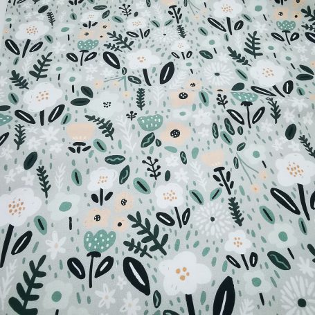 Tissu à motifs floraux colorés sur fond clair avec feuilles et fleurs stylisées.
